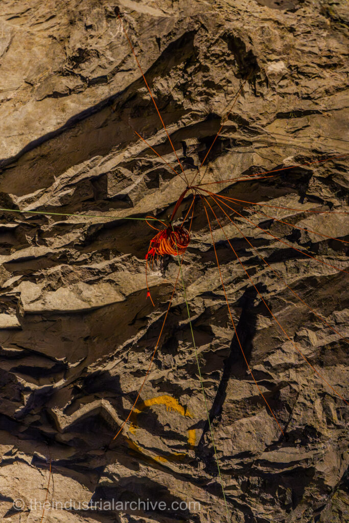 A photograph of wires connected to industrial explosives used in mining